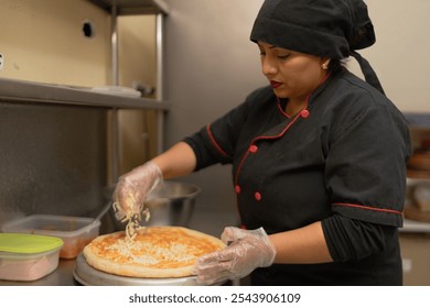 Female chef sprinkling mozzarella cheese on pizza dough, preparing delicious meal in commercial kitchen - Powered by Shutterstock