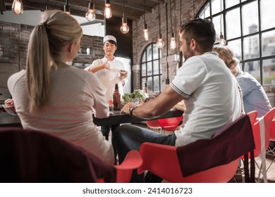 Female chef talking to students in cooking class - Powered by Shutterstock