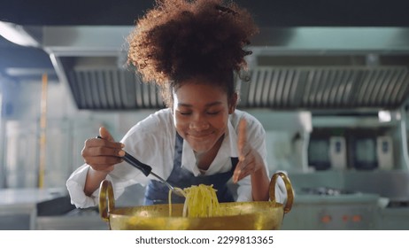 Female chef working at kitchen, She cooking food for customer at restaurant kitchen. Chef, Lifestyle, Working, Teamwork and Chef table concept. - Powered by Shutterstock