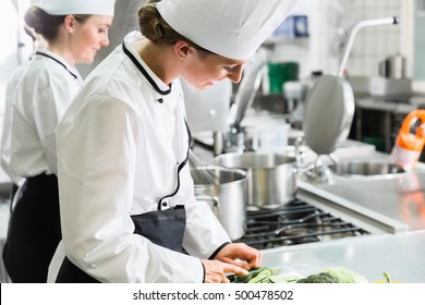 Female Chefs At Work In Industrial Kitchen Of Canteen 