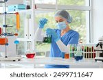 Female chemist with flask in laboratory