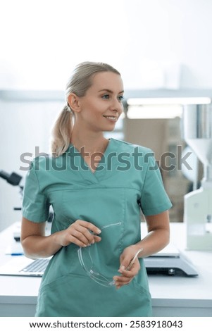 Similar – Image, Stock Photo Female chemist hand holding magnifying glass to analyze golden glitter sample on petri dish in lab