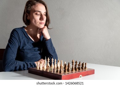 Female Chess Player Thinking Of Her Next Move.