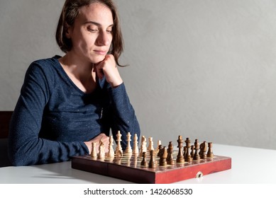 Female Chess Player Thinking Of Her Next Move.