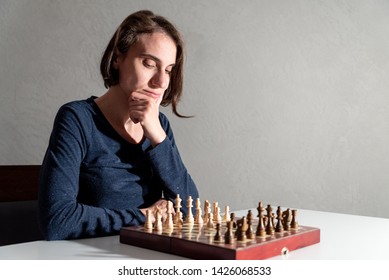 Female Chess Player Thinking Of Her Next Move.