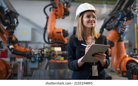 Female Chief Engineer In Modern Industrial Factory Using Tablet And Making Audit.