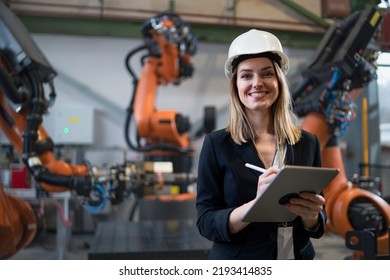 Female Chief Engineer In Modern Industrial Factory Using Tablet And Making Audit.