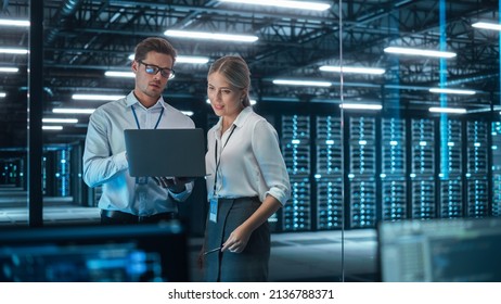 Female Chief Engineer Talks with Electronics Specialist, Explaining Things, While Works on Laptop Computer and Agrees with Her. Modern and Evening Office with Stylish Colleagues - Shutterstock ID 2136788371