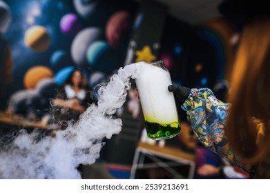 A female children's animator conducts a chemical experiment, experience, show with colored liquid in a glass flask with a smoke reaction for children. - Powered by Shutterstock