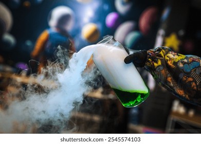 A female children's animator conducts a chemical experiment, experience, show with colored liquid in a glass flask with a smoke reaction for children. - Powered by Shutterstock