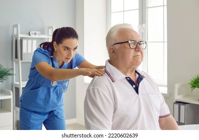 Female chiropractor or physiotherapist examining a senior male patient with spine problems and back pain. Health problems and professional physiotherapy treatment concept - Powered by Shutterstock