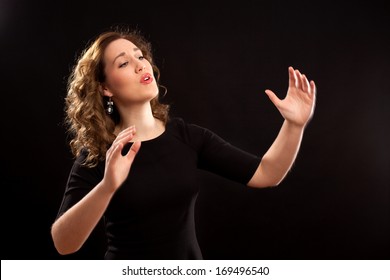 Female Choir Conductor During Performance