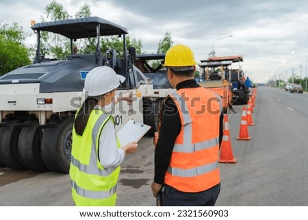 A female civil engineer consults with or with a contractor building a rural highway before commencing work to ensure completion. planning cooperation concept