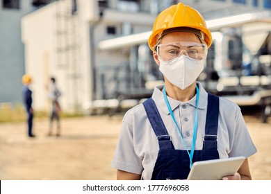 Female civil engineer wearing protective face mask while using touchpad at construction site during coronavirus pandemic.  - Powered by Shutterstock