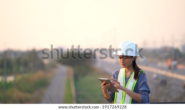 Female civil Engineering working with tablet on\
bridge highway
