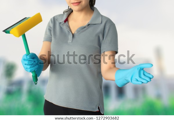 Female cleaning staff in factory blurred
background Metaphor for cleaning Get rid of germs In bathroom, home
office or industry.For reliability And satisfaction of service and
customers