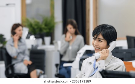 Female clerks answering the phone in the office.