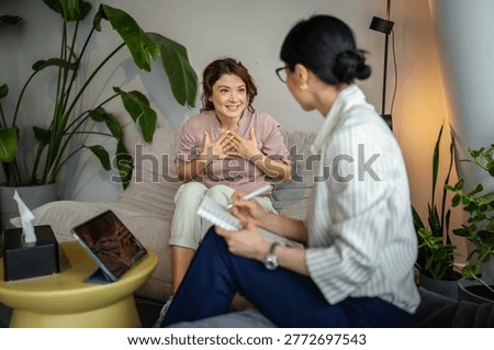 Female client discussing problems with a professional counselor, receiving support and advice during a psychological consultation in a calm office setting