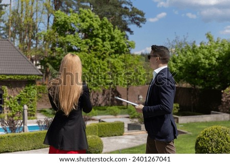 Female client inspects new cottage residence with realtor support. Businesswoman talks with real estate agent about mansion