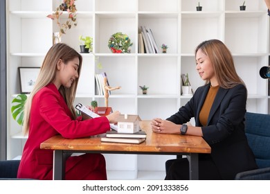 A Female Client Signs A Rental Application Form For A New House. Real Estate Agent Meets With Her Potential Client.