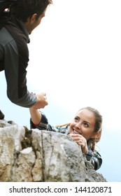 Female Climber Need A Help To Reach The Top Of The Mountain