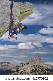 Female climber struggeling up a sheer cliff. - Shutterstock ID 625970102