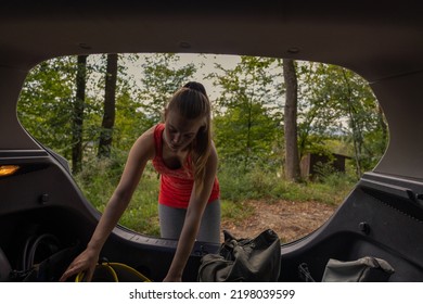 Female Climber Taking Climbing Gear Out Of The Car