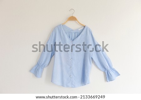 female clothes with hanger wooden on background.