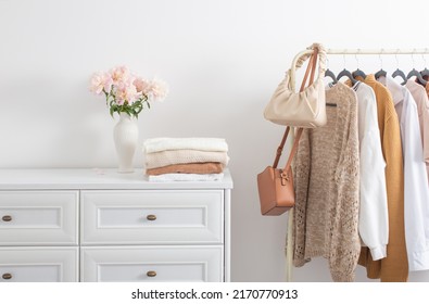 female clothes on hangers  in  white room