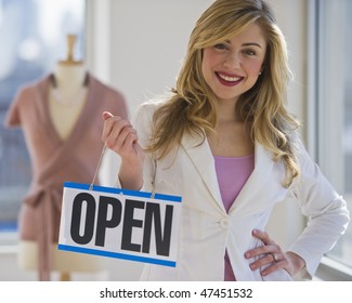 Female Clothing Store Worker Opening Up Shop