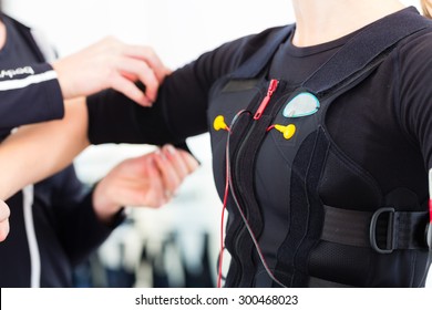 Female coach dress woman in ems electro muscular stimulation costume 