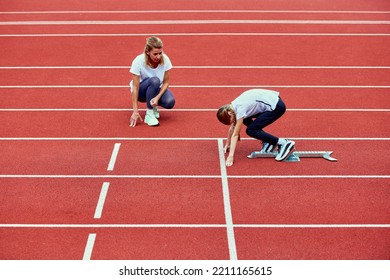 Female Coach Training Athlete. Fit Girl Getting Ready To Run On Treadmill At The Stadium. Concept Of Sport, Achievements, Studying, Goals, Skills. Little Teen Girl In Sportswear Training Outdoor.