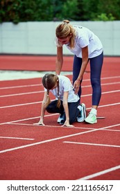 Female Coach Training Athlete. Fit Girl Getting Ready To Run On Treadmill At The Stadium. Concept Of Sport, Achievements, Studying, Goals, Skills. Little Teen Girl In Sportswear Training Outdoor.