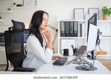 Female coder reviewing code, working remotely with organized desktop and ergonomic gear.