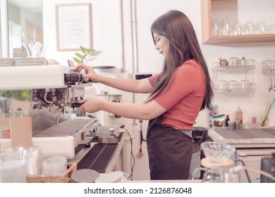 A Female Coffee Shop Business Owner Is Busy Making Coffee With The Coffee Machine In His Shop. Which The Atmosphere Is Filled With Happiness Today Is The First Day That The Shop Is Open.