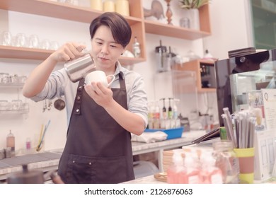 A Female Coffee Shop Business Owner Is Busy Making Coffee In His Shop She Is Serving Coffee That Tastes Great. Which The Atmosphere Is Filled With Happiness .