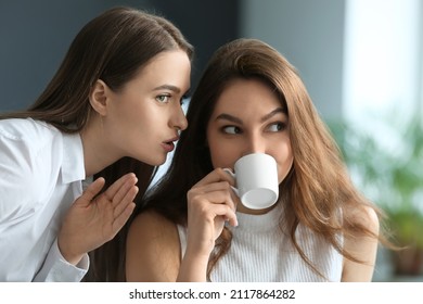 Female colleagues gossiping in office