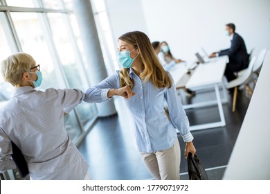 Female Colleagues Keeping Social Distance In The Office, Greeting Each Other By Bumping Elbows, Preventing Covid 19 Coronavirus Infection Spread