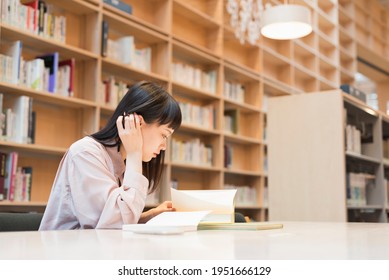 Female college student in the library - Shutterstock ID 1951666129