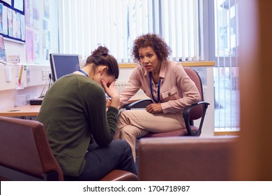 Female College Student Meeting With Campus Counselor Discussing Mental Health Issues