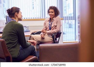 Female College Student Meeting With Campus Counselor Discussing Mental Health Issues