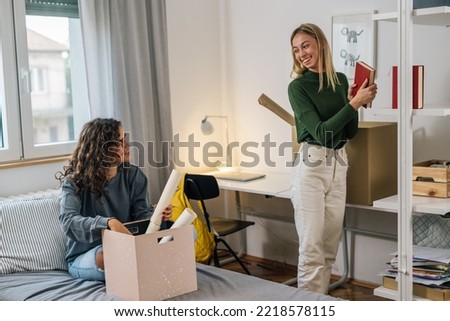 female college student move in dorm. they are talking in the room