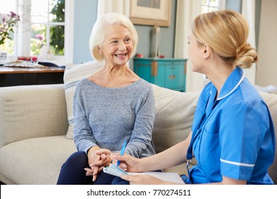 Female Community Nurse Visits Senior Woman At Home