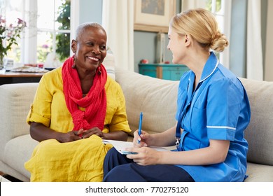 Female Community Nurse Visits Senior Woman At Home