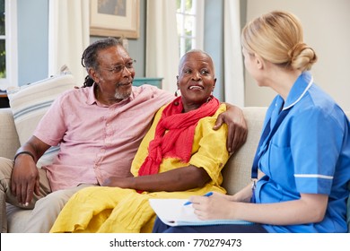 Female Community Nurse Visits Senior Couple At Home