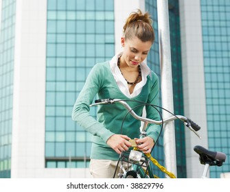 female commuter locking padlock to her bike. Copy space - Powered by Shutterstock