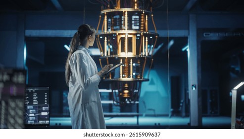 Female Computer Engineer Examining a Quantum Computer in a High Tech Scientific Laboratory. Professional Scientist in White Coat Typing Research and Development Analytics in Her Tablet Computer