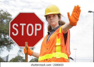 A Female Construction Worker Holding A Stop Sign.