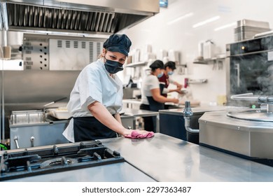 female cook cleaning her kitchen after work