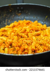 Female Cook Tossing Egg Pasta In The Pan